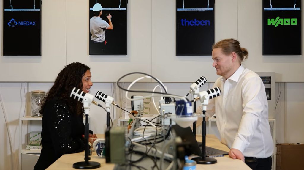 Podcastgesprek tussen man en vrouw met microfoons